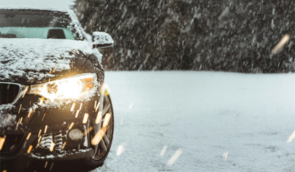 black car on snow covered road during daytime
